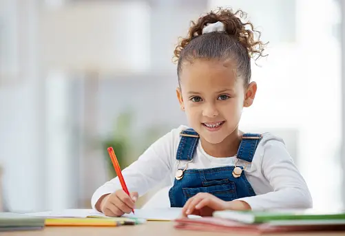 Cute little girl doing homework. 