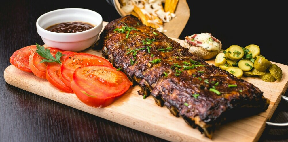 a slab of ribs displayed on a cutting board to show why Crossbuck BBQ is the Best Barbecue in Texas